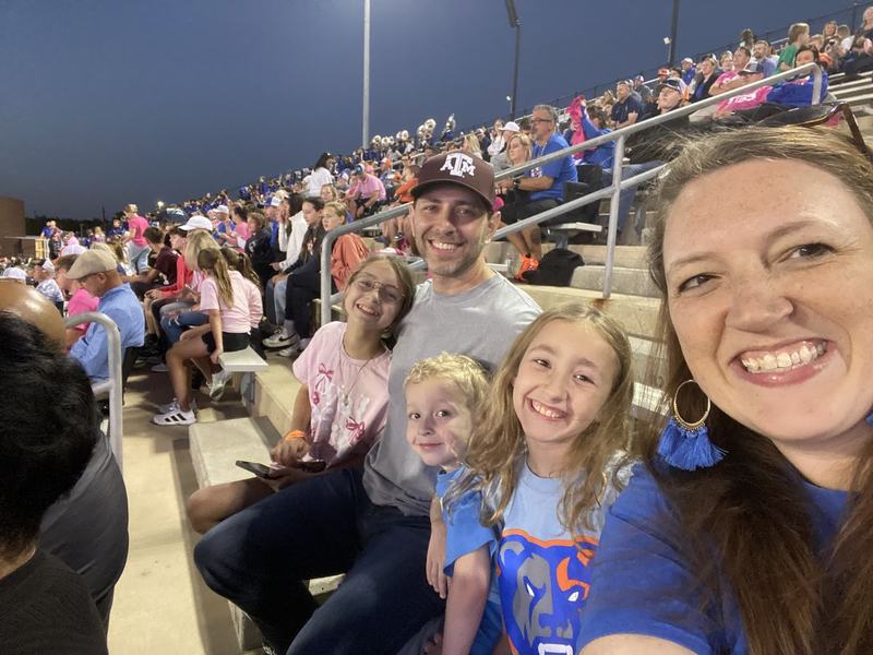 The family cheering at a football game